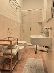 a bathroom with a sink and a toilet and a shower at L'Angolo di Palermo in Palermo