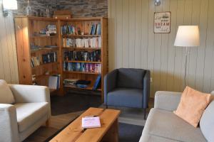 a living room with a couch and a chair and a table at Calma do Mar in Madalena