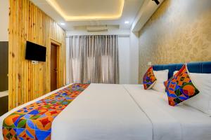 a bedroom with a large white bed and a television at Via Blissful Stays in Mumbai