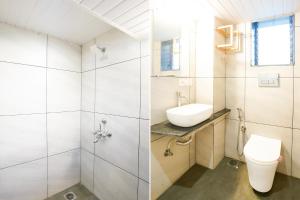 a bathroom with a toilet and a sink at Via Blissful Stays in Mumbai +16 photos