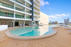 a swimming pool in the middle of a building at Darwin Central Escape Hotel Style Apartment with Kitchen , Pool , Gym , Car Park,Balconey in Darwin