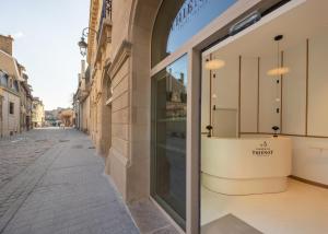 a shop window on a street in a city at Boutique-Hôtel Le N3 par Champagne Thiénot in Reims