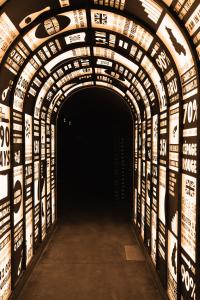 a dark tunnel with signs on the walls at Boutique-Hôtel Le N3 par Champagne Thiénot in Reims +32 photos