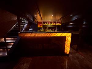 a bar in a dark room with a counter at Hotel Alka Residency in Thane