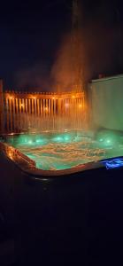 a pool of water with lights in it at night at Villa It's Arctic Magic! in Rovaniemi