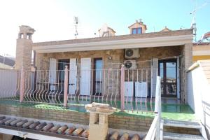 a house with a fence in front of it at B&B Sa Sinniesa in Sìnnai