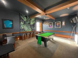 a billiard room with a green table in it at The Square Kintore in Kintore