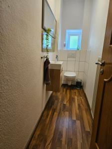 a bathroom with a toilet and a sink at Ferienwohnung Apfelbaum Kitzingen in Kitzingen +6 photos