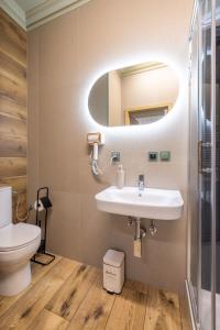 a bathroom with a sink and a mirror at Positano Apartment in Głowno +6 photos