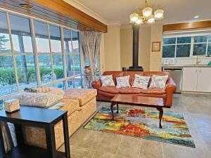 a living room with a couch and a table at Grandvista Cottage in Yering