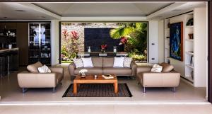 a living room with two couches and a coffee table at Tropical heaven in Les Trois-Îlets
