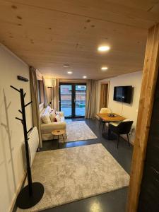 a living room with a couch and a table at Little Chalet Piguet in Gryon
