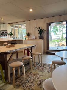 a room with tables and chairs and a large window at Kanzaki Beach House in Kanzaki