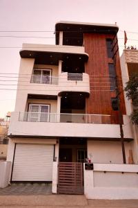 a building with a balcony on the side of it at OddbirdStays in Indore