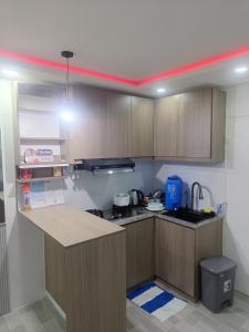 a kitchen with wooden cabinets and a counter top at Charming 2-Bedroom Balanga Getaway with Ample Space in Balanga