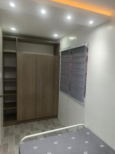 a bedroom with a bed and a closet with a window at Charming 2-Bedroom Balanga Getaway with Ample Space in Balanga