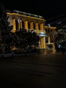 a building lit up at night with christmas lights at Ember Residence Spacious 2BR Apartment near Eternal Flame in Sarajevo