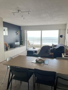 a living room with a table and a couch at Golden Sun in Middelkerke