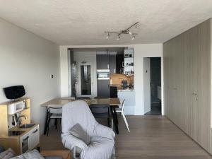 a living room and kitchen with a table and chairs at Golden Sun in Middelkerke
