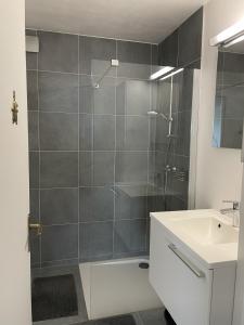 a bathroom with a shower and a sink at Golden Sun in Middelkerke