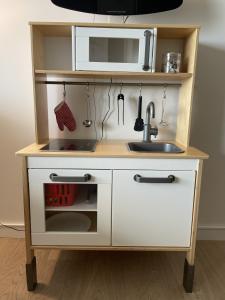 a kitchen island with a sink and a microwave at Golden Sun in Middelkerke +10 photos