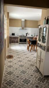 a kitchen and dining room with a table and a kitchen with at La Luján Ayres de Campo in Luján