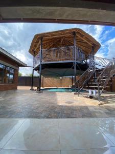 a large building with a playground with a slide at PreshyPride Guest House in Victoria Falls