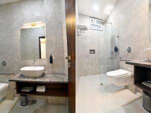 a bathroom with a sink and a toilet and a shower at Nyotel-MP Nagar Bhopal in Bhopal +17 photos