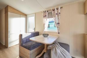 a tiny house with a table and a chair at Host and Stay - 421 Wooler Park in Wooler +15 photos