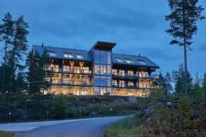 a large building with many windows on a hill at Naava Chalet 401 Penthouse - Järvinäköala ilta-aurinkoon in Ähtäri