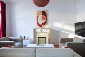a living room with a couch and a fireplace at Le Saint-Quentin - Studio avec Terrasse in Saint-Quentin