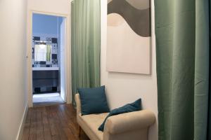 a living room with a couch and a mirror at Le Saint-Quentin - Studio avec Terrasse in Saint-Quentin +7 photos