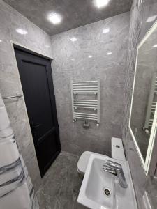 a bathroom with a sink and a black door at Terrace house Jermuk in Jermuk