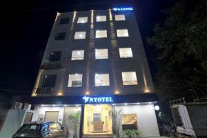 a tall building with a sign in front of it at Nyotel-MP Nagar Bhopal in Bhopal