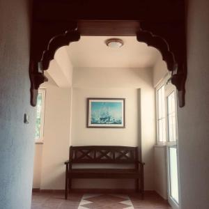 a hallway with a bench and a picture on the wall at Turunç Barbaros Apart in Marmaris