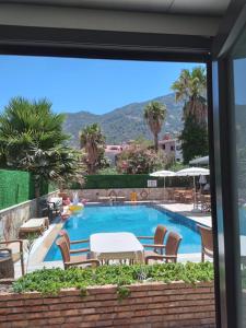 a view of a swimming pool from a window at Turunç Barbaros Apart in Marmaris
