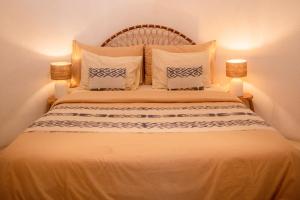 a bedroom with a large bed with white sheets and pillows at Pachamama Pool Villa in Gili Islands