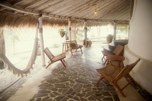 a living room with rocking chairs and a couch at Pachamama Pool Villa in Gili Islands