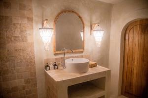 a bathroom with a sink and a mirror at Pachamama Pool Villa in Gili Islands +24 photos