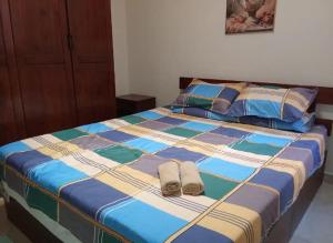 a bed with two slippers sitting on top of it at Chalet On the Beach in Alexandria