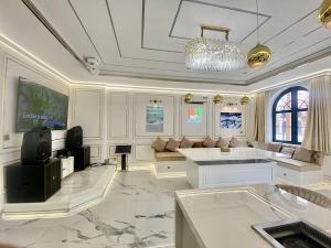 a large white room with a chandelier at PKseahome 3 bedroom 4 toilet Novaworld in Phan Thiet