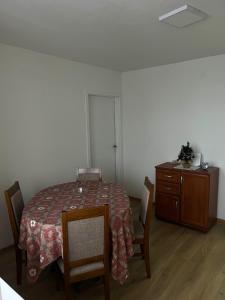 a dining room with a table and chairs and a dresser at Stan na dan Žabac in Vlasenica