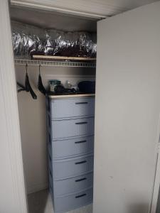 a closet with a bunch of drawers and a shelf at Bridgeport East Main in Bridgeport