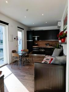 a living room with a couch and a table at Orelli House - Bilocal Garden in Lissone