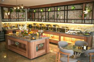 a restaurant with a bar with tables and chairs at Domont Hotel in Erbil