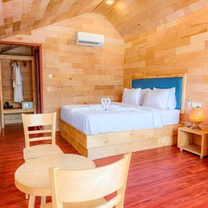 a bedroom with a bed and a table and chairs at Royal C Resort in Koh Rong Island