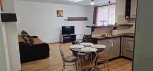 a kitchen and a living room with a table and chairs at DD's place in Sibiu