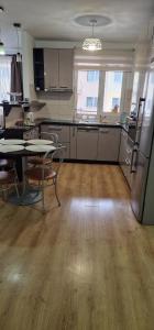 a large kitchen with a table and chairs in a room at DD's place in Sibiu +15 photos