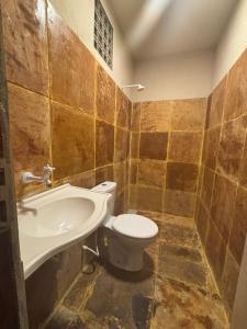 a bathroom with a toilet and a sink at Casa Girasol in Trairi +32 photos