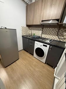 a kitchen with a stove and a washing machine at Terrace house Jermuk in Jermuk +3 photos